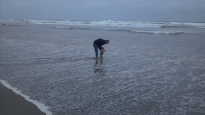 Father and son playing in the ocean surf