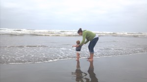 Baby boy apprehensive about the ocean tide coming in